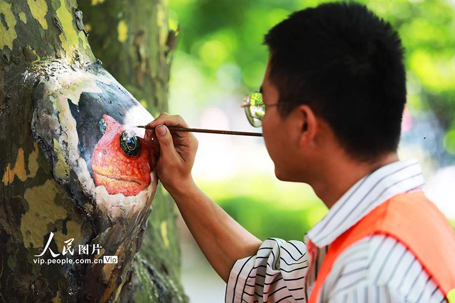 POTRET: Tutupi Luka Pohon dengan Lukisan-Image-1